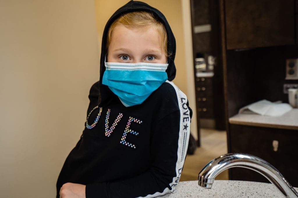 Young Female Patient in Mask in Thomas Dentistry Seattle